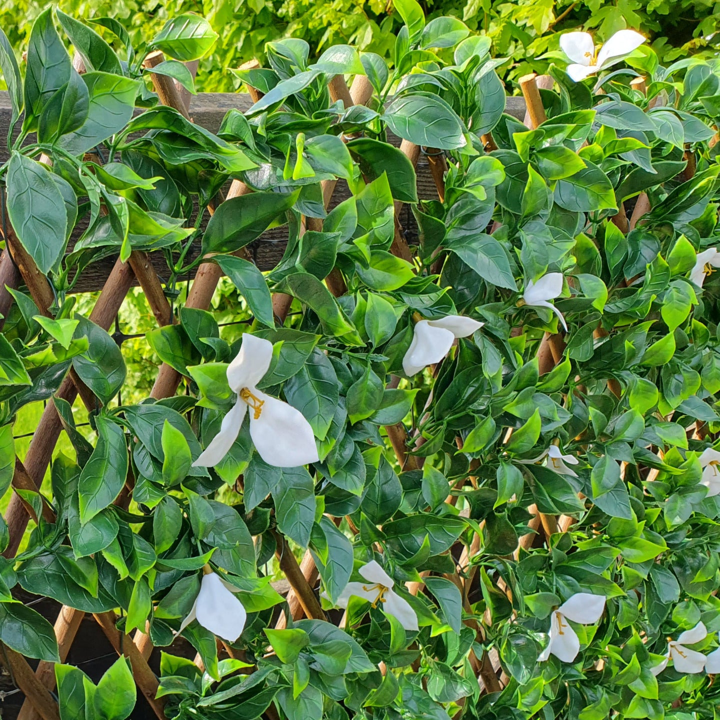 Artificial Laurel & White Flower Expanding Willow Trellis Fence